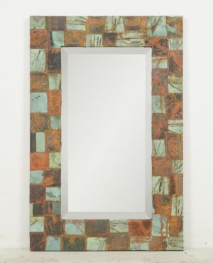 Rectangular wall mirror with a patchwork copper frame and beveled center mirror.