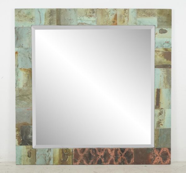 Square wall mirror with a beveled center and a handcrafted patchwork copper frame in verdigris tones, showing a mounting wire at the bottom edge.