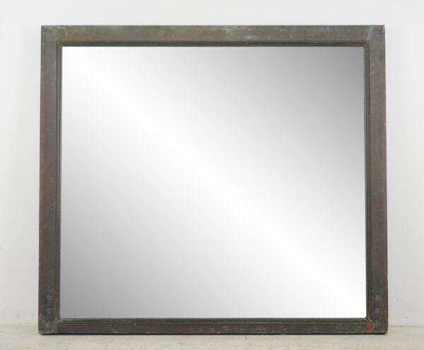 Rectangular mirror in an antique brass window frame with a simple wide border and plain reflective center.