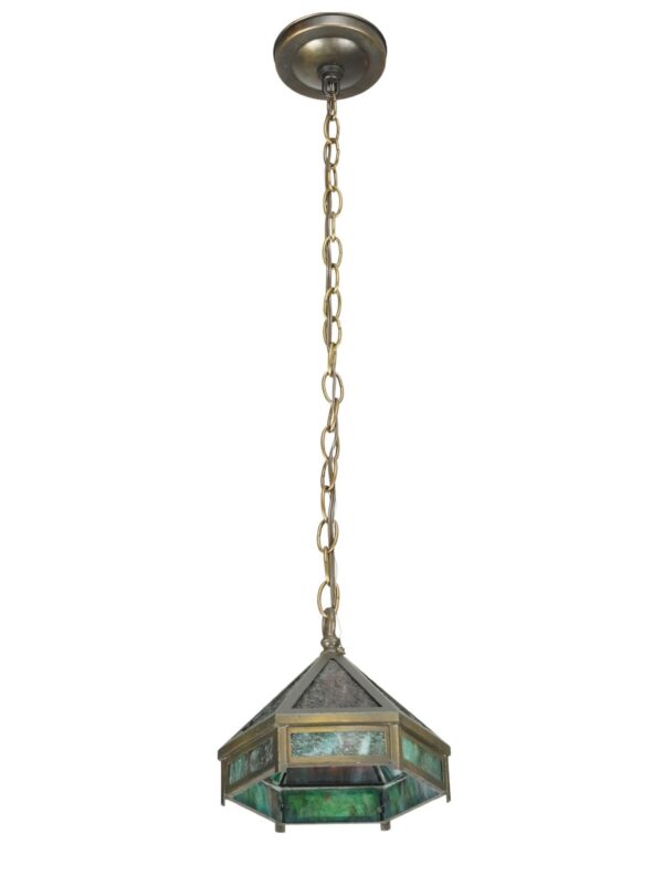 Arts & Crafts pendant light with a hexagonal shade, marbled green slag glass panels, brass framing, and a hanging chain.