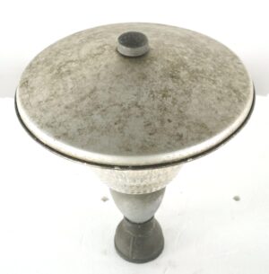 Exterior street lamp post top with a wide brushed steel cap, clear Holophane glass body, and bronze pedestal base, shown from above with surface wear.