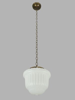 Art Deco pendant light with a milk glass globe and antique brass chain fitter hanging from a round ceiling mount.