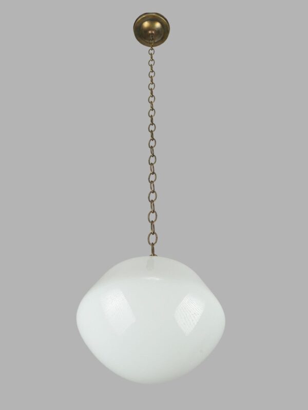Schoolhouse pendant light with a white milk glass globe and an antique brass chain fitter.