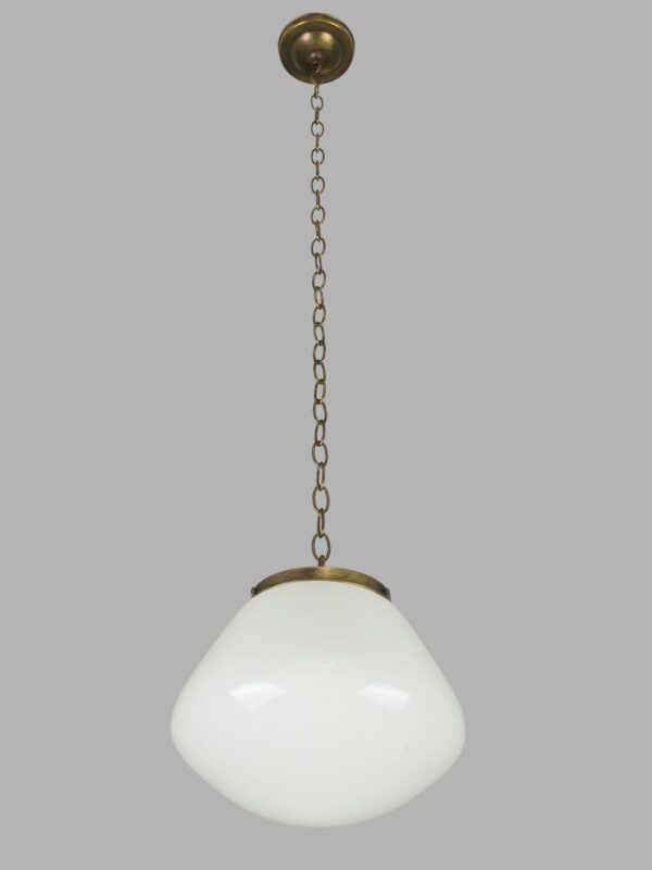 Schoolhouse pendant light with a milk glass globe and antique brass chain fitter.