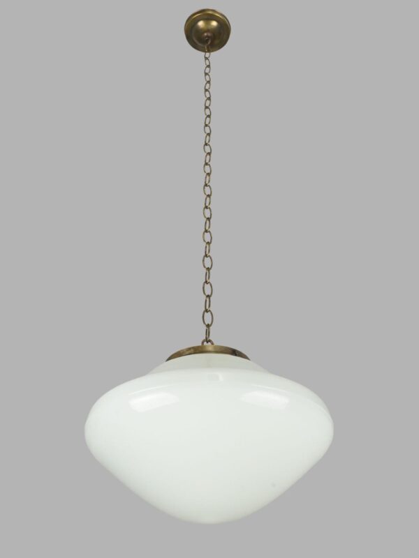 Schoolhouse pendant light with a milk glass globe and antique brass chain fitter.