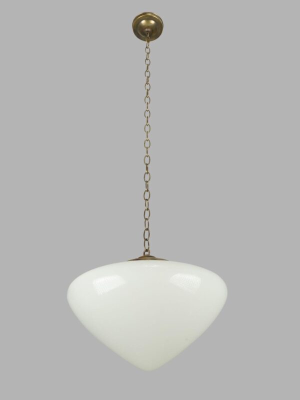 Art Deco pendant light with a milk glass globe and antique brass chain fitter.