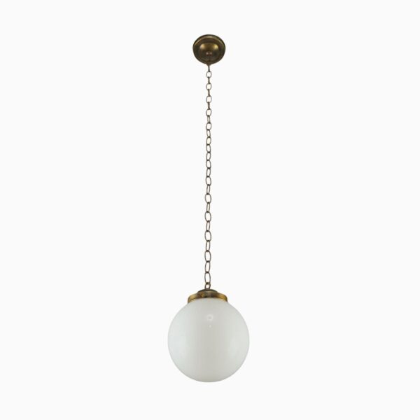 Schoolhouse pendant light with an opaline glass globe, antique brass chain, and round ceiling mount.