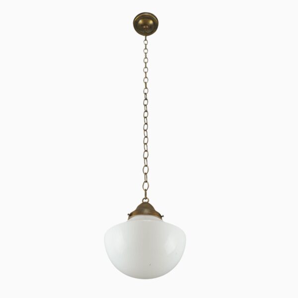Schoolhouse pendant light with a milk glass globe and antique brass chain fitter.