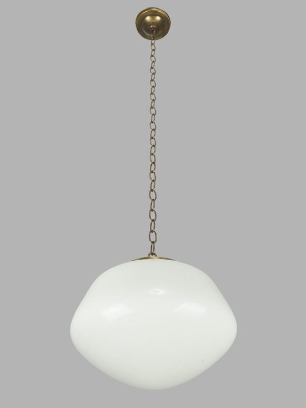 Schoolhouse pendant light with a white milk glass globe and antique brass chain fitter.