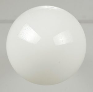 Schoolhouse pendant light with a milk glass globe shown in close-up.
