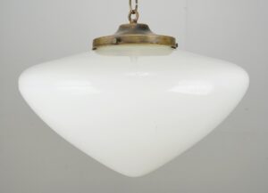Art Deco pendant light with a white milk glass shade and antique brass fitter, shown from below.