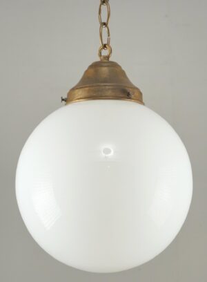 Schoolhouse pendant light with a white ball glass globe and antique brass chain fitter.