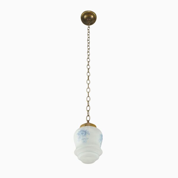 Vintage pendant light with an antique brass chain and a white glass globe with blue floral pattern.