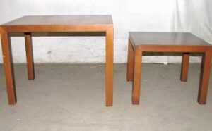 Pair of mid-century walnut nesting side tables with straight block legs, shown together in a wider view.