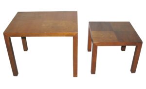 Pair of mid century nesting side tables in medium wood tone walnut, shown as two square tables with checkerboard parquet tops and straight block legs.