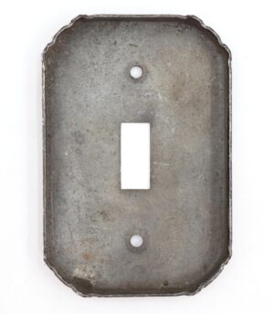 Distressed black steel toggle switch wall plate with one rectangular opening and two mounting holes, shown from the front.