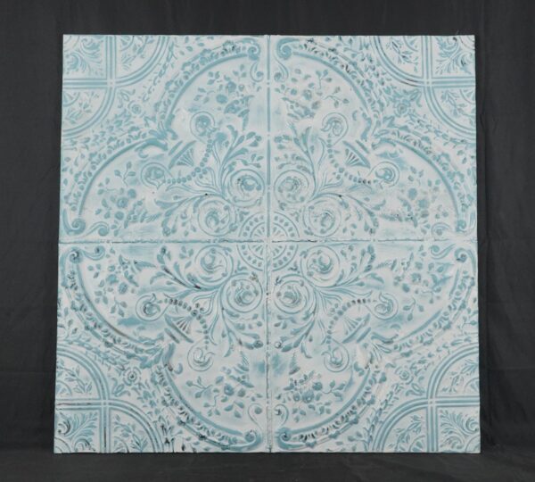 Handcrafted blue tin wall panel with an ornate four-quadrant ceiling pattern and floral scrollwork.