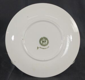 White porcelain plate shown from the back with the green Boch Rambouillet maker's mark in the center.