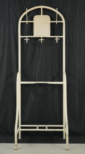 Vintage white steel hall tree stand with five hooks, a bottom shelf, and visible surface wear.