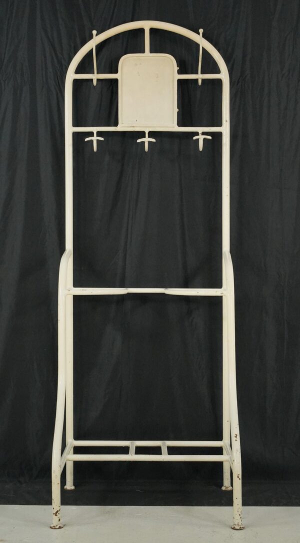 Vintage white steel hall tree stand with five hooks, a bottom shelf, and visible surface wear.