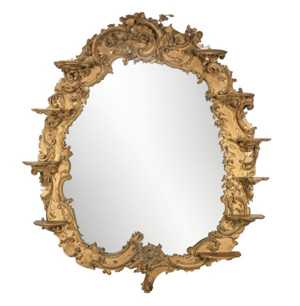 Ornate Rococo Revival wall mirror with an arched gilt frame, decorative scrollwork, and multiple candle shelves.