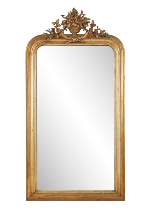 Louis Philippe wall mirror with rounded upper corners, a straight bottom edge, and an urn-and-foliage crest on the frame.