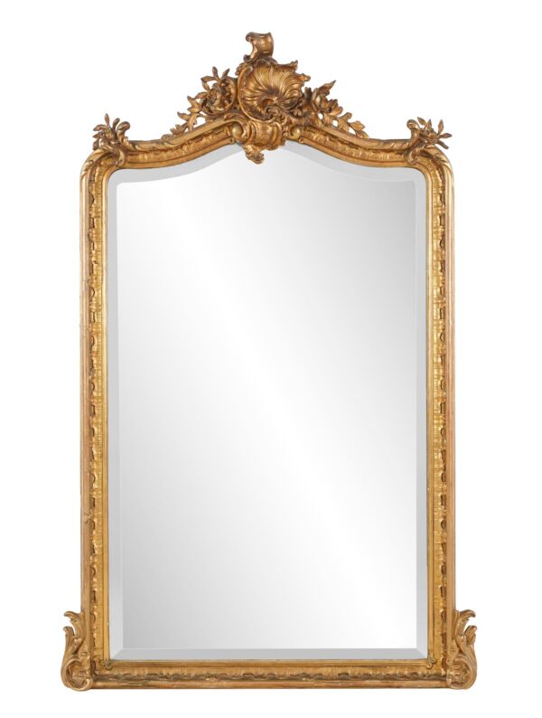 Ornate Louis XV wall mirror with a tall gilt frame, curved crest, and carved foliage details, shown front facing.