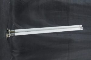 Mid century double arm towel rack with white milk glass arms and a nickel bracket shown in side view.