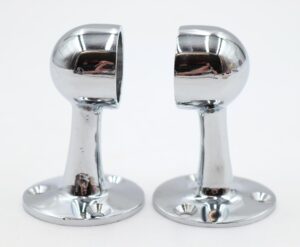 Pair of chrome towel bar brackets shown as a matching set, each with a rounded top, narrow stem, and circular base with mounting holes.