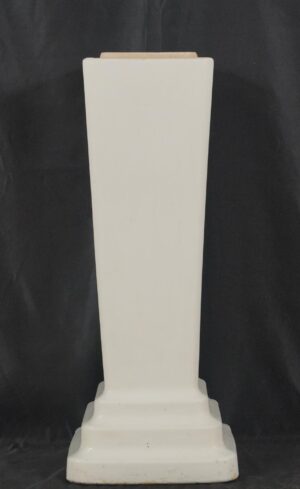 White ceramic sink pedestal base with a tapered column shape and stepped footed base, shown front view with the top opening visible.