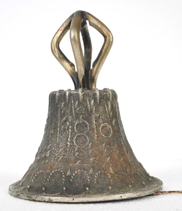 Vintage cast iron handbell with an antique brass handle and textured blackened body, shown with a wire attached to the clapper and visible surface wear.