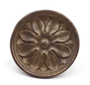 Round cast brass drawer pull with a raised floral design and aged finish, shown from the front.