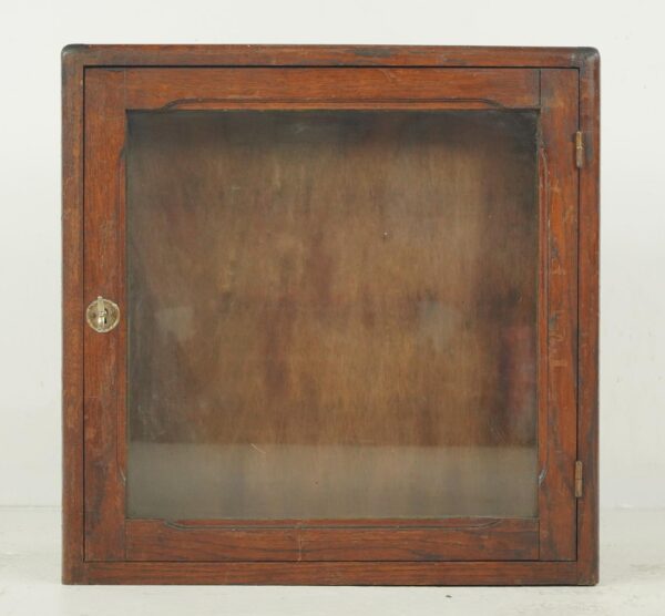 Vintage industrial display cabinet with a dark wood tone frame, glass front, and brass latch.