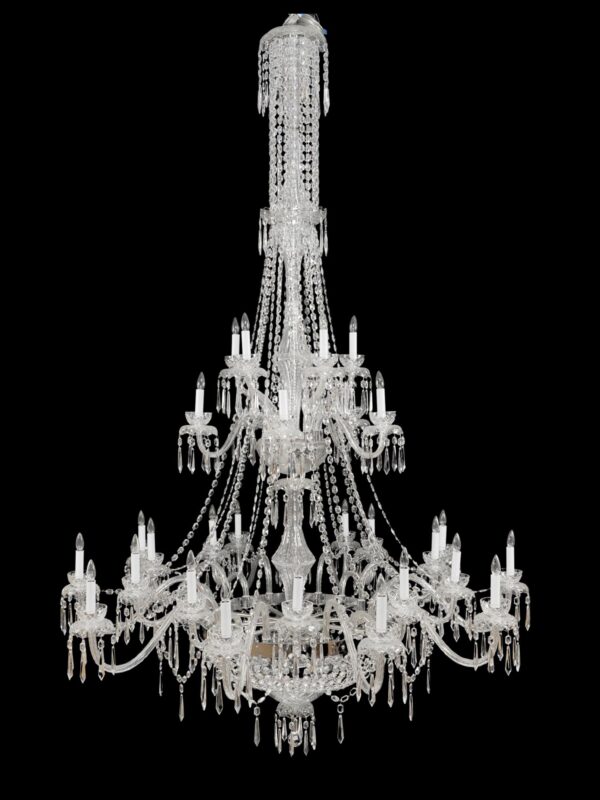 Clear crystal chandelier with multiple tiers, 18 arms, and hanging prisms, shown in a frontal view against a black background.