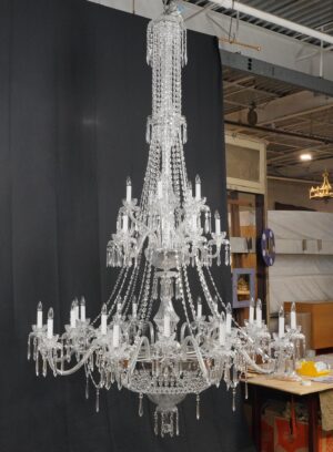 A grand crystal chandelier with multiple tiers, 18 arms, and hanging crystal strands, shown full length with candle-style bulb sockets.