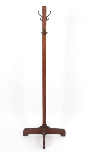 Free-standing coat rack with a tall dark wood pole, four triple hooks near the top, and a wide base with a central support bar.