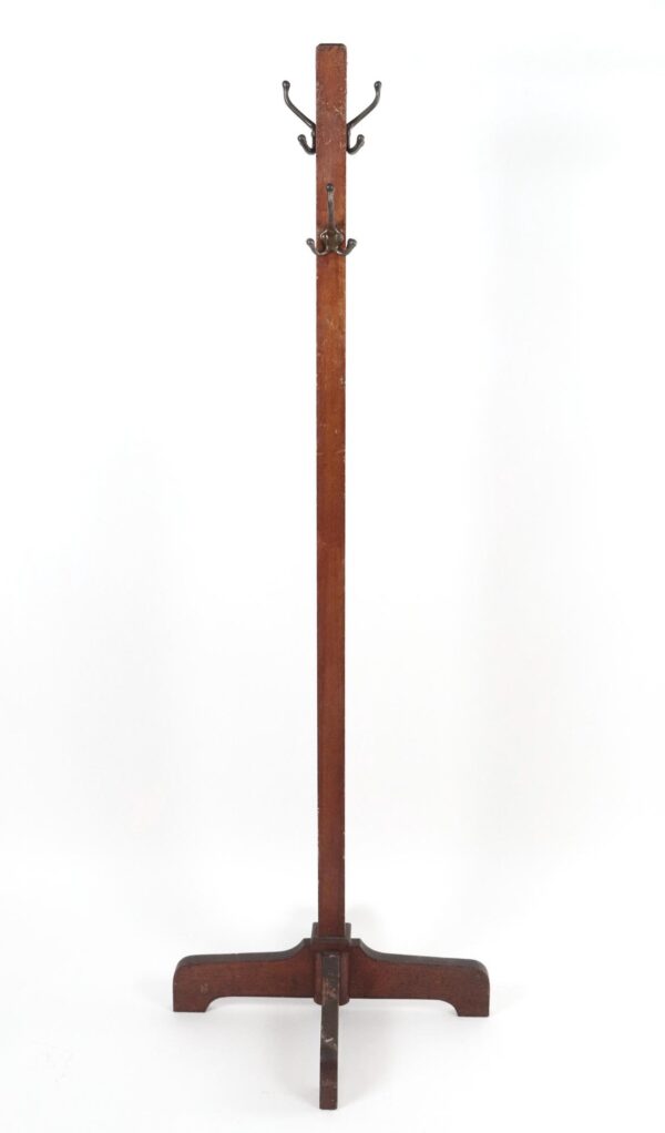 Free-standing coat rack with a tall dark wood pole, four triple hooks near the top, and a wide base with a central support bar.