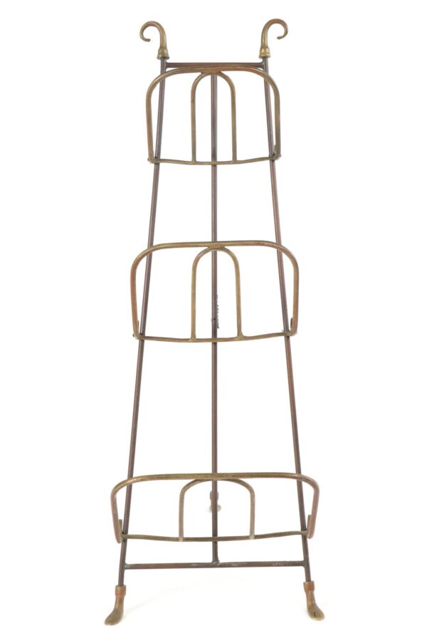 Antique brass three-tier magazine rack with curved handles, shown front view on a tripod base with curved feet.