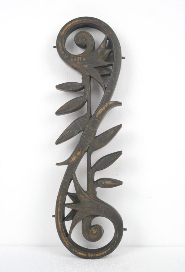 Art Nouveau bronze metal piece with spiral ends, leaf-like details, and side lugs, shown vertically with worn antique bronze finish.