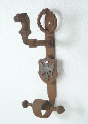 Gothic wrought iron double door pull with an eagle shield and lower ring knocker visible in a vertical view.