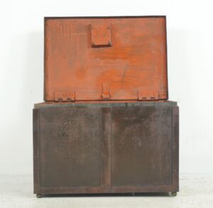 Rectangular brown metal vault unit with an upper hinged panel and lower front section, shown closed and worn, with the key included.