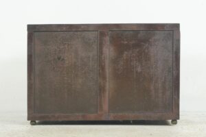 Rectangular brown metal vault unit with two front panels and a worn surface, shown closed with small feet at the bottom.