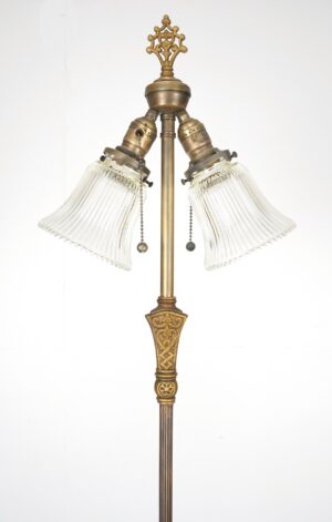 Victorian two-light floor lamp with clear ribbed glass shades, ornate gold accents, and a brass pole.