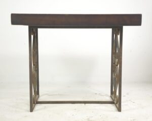 Side table with a dark wood tone pine top and wrought iron base, shown front on with heart and scroll motifs on the legs.