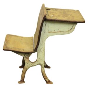 Antique cast iron number 4 tandem school desk with a light green base and dark wood seat and writing surface, shown in side view with a pen groove and inkpot hole visible.