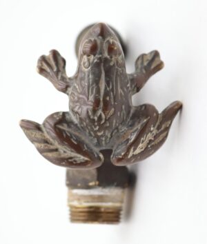 Antique-style brass garden water spigot with a frog-shaped turn handle and visible surface wear.