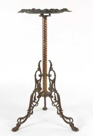 Victorian brass plant stand with a scalloped top, twisted central column, and ornate scrolling legs.