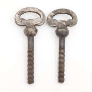 Pair of traditional mirror screws with oval nickel-plated brass heads and steel threaded shafts, shown as a pair with visible surface wear and rust.