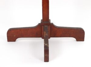 Oak coat rack with a quadripod base and a central pole, shown from the lower section with surface wear and chipped wood visible.