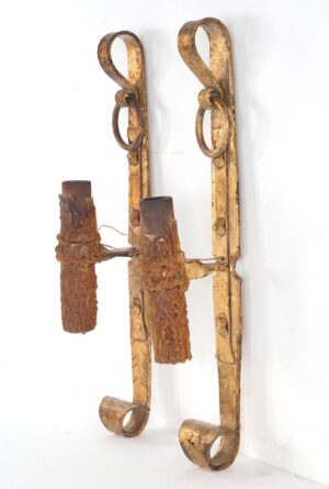 Pair of Spanish Revival wall sconces with gilt scrollwork, shown as a matching pair with textured candle sleeves and looped forms at the top and bottom.